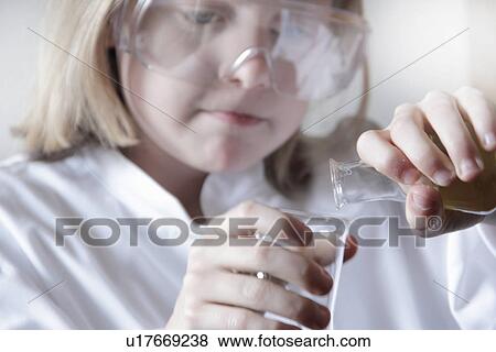 Girl pouring liquid into beakers View Large Photo Image Stock Photo - Girl pouring liquid into beakers. Fotosearch