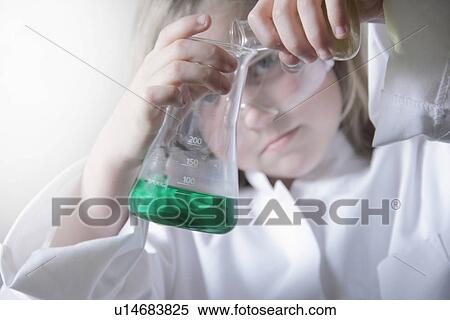 Stock Photography - Girl pouring liquid into beakers. Fotosearch