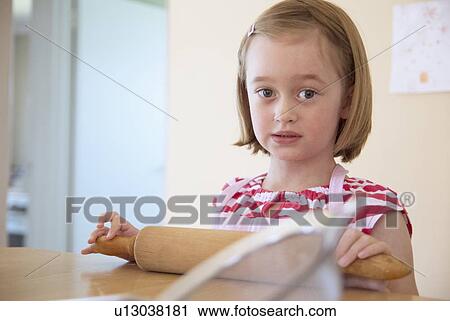 Girl using rolling pin in kitchen View Large Photo Image Stock Image - Girl using rolling pin in kitchen. Fotosearch