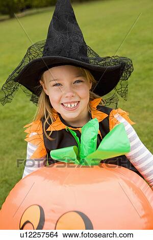 Picture - Girl wearing Halloween costume outdoors. Fotosearch