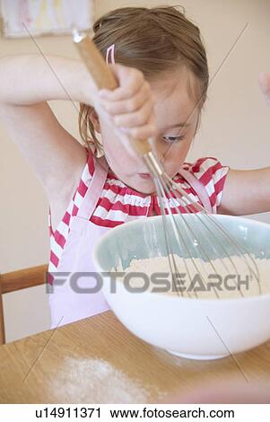 Girl whisking flour in kitchen View Large Photo Image Stock Image - Girl whisking flour in kitchen. Fotosearch