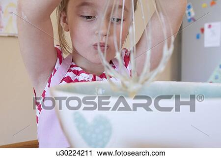 Girl whisking in kitchen View Large Photo Image Stock Image - Girl whisking in kitchen. Fotosearch