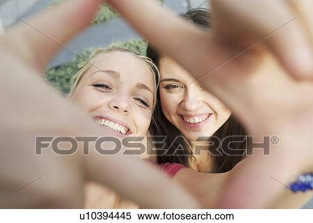 Girls making faces on city street View Large Photo Image Stock Photography - Girls making faces on city street. Fotosearch