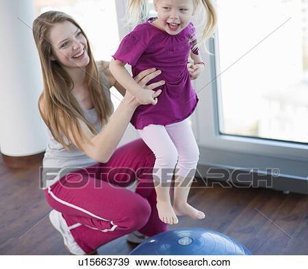 Girls playing with exercise ball in gym View Large Photo Image Stock Photo - Girls playing with exercise ball in gym. Fotosearch