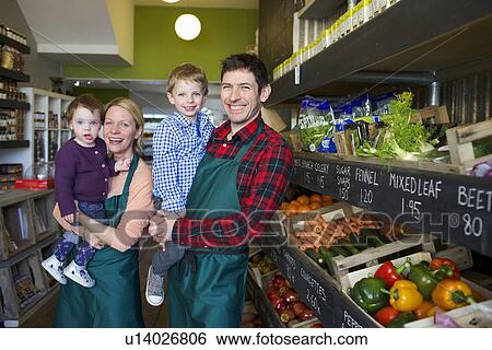 Grocers holding children in store View Large Photo Image Stock Photograph - Grocers holding children in store. Fotosearch