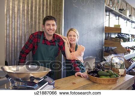 Grocers smiling together in store View Large Photo Image Stock Photograph - Grocers smiling together in store. Fotosearch