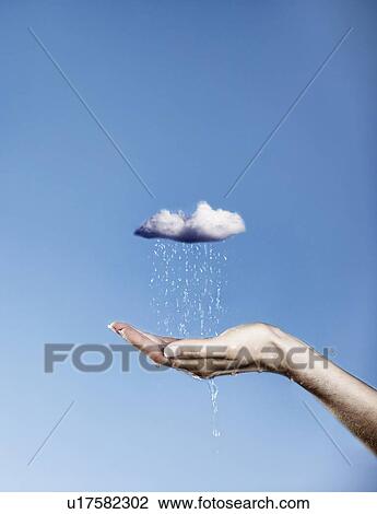 Hand holding pouring rain cloud View Large Photo Image Stock Image - Hand holding pouring rain cloud. Fotosearch