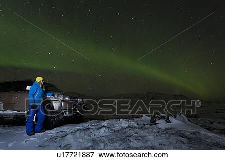 Hiker admiring aurora borealis View Large Photo Image Stock Photo - Hiker admiring aurora borealis. Fotosearch