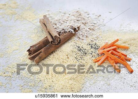 Stock Image - Ingredients for vegan muffin - Cinnamon, quinoa flour, carrots, oats. Fotosearch