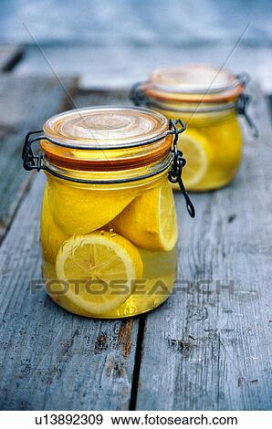 Jar of lemons in juice View Large Photo Image Stock Photo - Jar of lemons in juice. Fotosearch