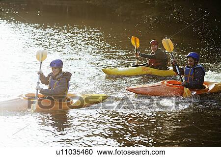 Kayakers rowing together on still lake View Large Photo Image Stock Image - Kayakers rowing together on still lake. Fotosearch