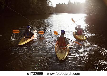 Kayakers rowing together on still lake View Large Photo Image Stock Image - Kayakers rowing together on still lake. Fotosearch