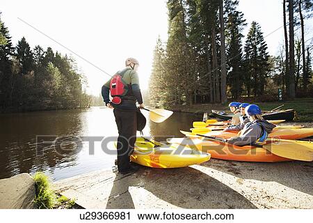 Kayaks lined up at edge of lake View Large Photo Image Stock Image - Kayaks lined up at edge of lake. Fotosearch