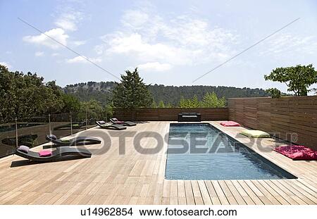 Lawn chairs and pool on modern deck View Large Photo Image Picture - Lawn chairs and pool on modern deck. Fotosearch