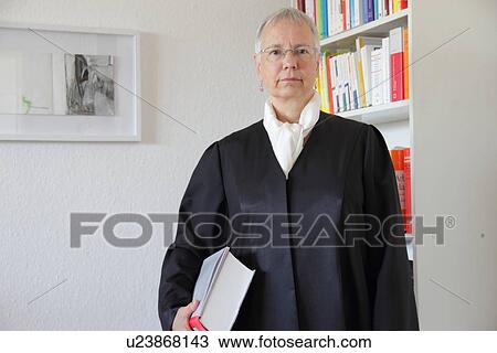 Lawyer holding text book in office View Large Photo Image Stock Image - Lawyer holding text book in office. Fotosearch