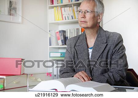 Lawyer reading text book in office View Large Photo Image Stock Photo - Lawyer reading text book in office. Fotosearch