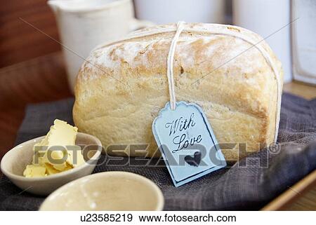 Stock Photo - Loaf of bread with butter on cloth. Fotosearch