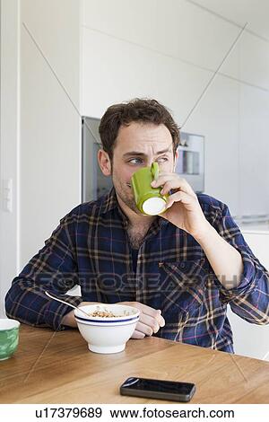 Man having breakfast at table View Large Photo Image Stock Photo - Man having breakfast at table. Fotosearch