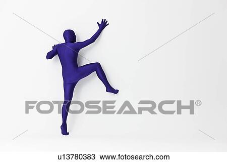 Man in bodysuit scaling wall View Large Photo Image Stock Image - Man in bodysuit scaling wall. Fotosearch