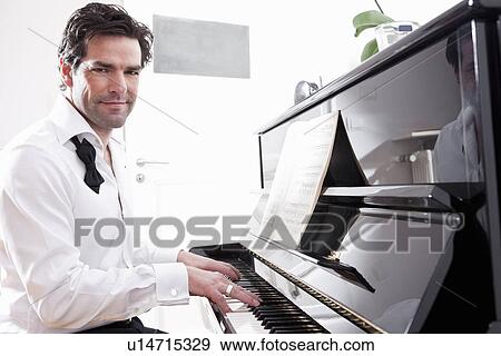 Man in tuxedo playing piano View Large Photo Image Stock Photo - Man in tuxedo playing piano. Fotosearch