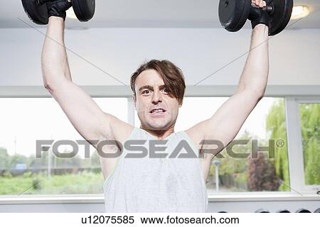 Man lifting weights in gym View Large Photo Image Stock Photography - Man lifting weights in gym. Fotosearch