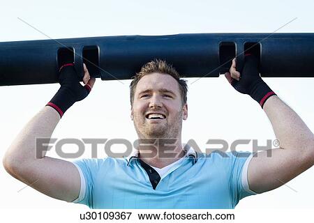 Man lifting weights outdoors View Large Photo Image Stock Photo - Man lifting weights outdoors. Fotosearch