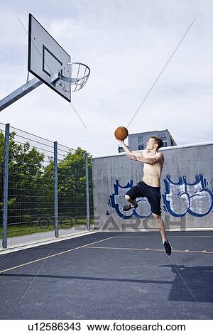 Man playing basketball on urban court View Large Photo Image Stock Image - Man playing basketball on urban court. Fotosearch