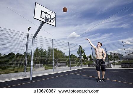 Man playing basketball on urban court View Large Photo Image Stock Photo - Man playing basketball on urban court. Fotosearch