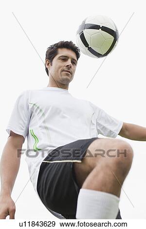 Man playing with soccer ball in field View Large Photo Image Stock Photo - Man playing with soccer ball in field. Fotosearch