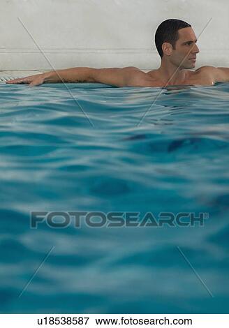 Man relaxing in infinity pool View Large Photo Image Stock Photo - Man relaxing in infinity pool. Fotosearch