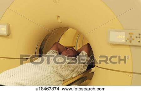 Man relaxing in MRI machine View Large Photo Image Picture - Man relaxing in MRI machine. Fotosearch