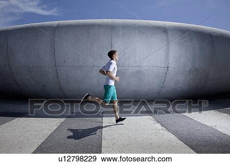 Stock Photo - Man running in industrial area. Fotosearch