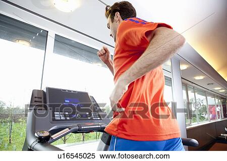Man running on treadmill in gym View Large Photo Image Stock Photography - Man running on treadmill in gym. Fotosearch