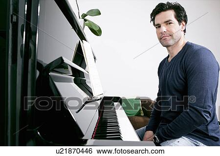 Man sitting at piano View Large Photo Image Stock Photograph - Man sitting at piano. Fotosearch