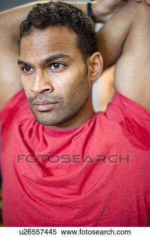 Stock Photography - Man stretching on spin machine. Fotosearch