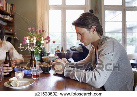 Man using cell phone at dinner table View Large Photo Image Stock Image - Man using cell phone at dinner table. Fotosearch