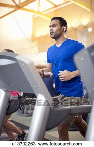 Man using treadmill in gym View Large Photo Image Stock Image - Man using treadmill in gym. Fotosearch