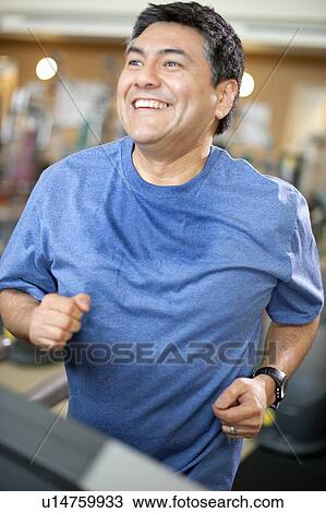 Man using treadmill in gym View Large Photo Image Stock Image - Man using treadmill in gym. Fotosearch