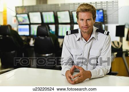 Picture - Man working in security control room. Fotosearch
