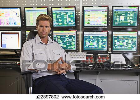 Man working in security control room View Large Photo Image Stock Image - Man working in security control room. Fotosearch