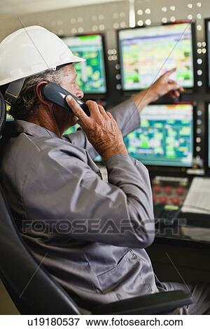 Man working in security control room View Large Photo Image Stock Photo - Man working in security control room. Fotosearch