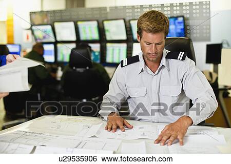 Man working in security control room View Large Photo Image Stock Photograph - Man working in security control room. Fotosearch