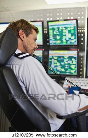 Man working in security control room View Large Photo Image Stock Photography - Man working in security control room. Fotosearch