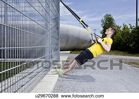Stock Photo - Man working out in industrial area. Fotosearch