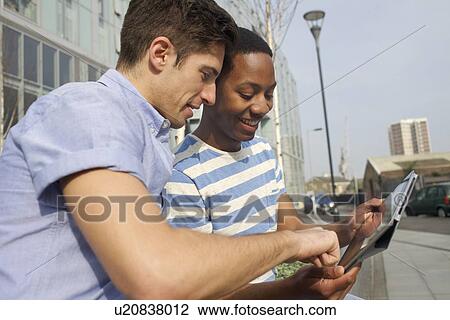 Men using tablet computer on street View Large Photo Image Stock Image - Men using tablet computer on street. Fotosearch