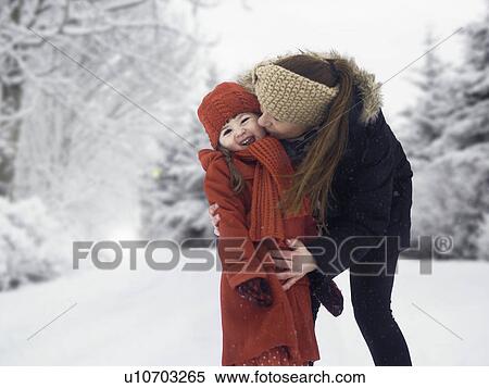 Mother and daughter kissing in snow View Large Photo Image Stock Photography - Mother and daughter kissing in snow. Fotosearch