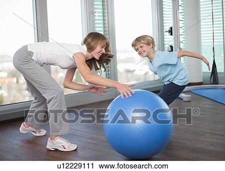 Mother and son playing in gym View Large Photo Image Stock Image - Mother and son playing in gym. Fotosearch