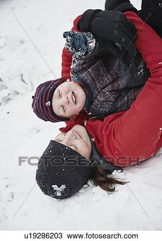 Mother and son playing in snow View Large Photo Image Stock Image - Mother and son playing in snow. Fotosearch