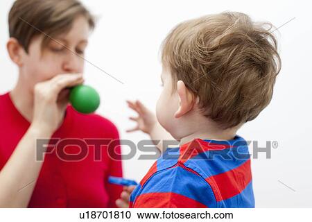 Mother blowing balloon for son View Large Photo Image Stock Image - Mother blowing balloon for son. Fotosearch
