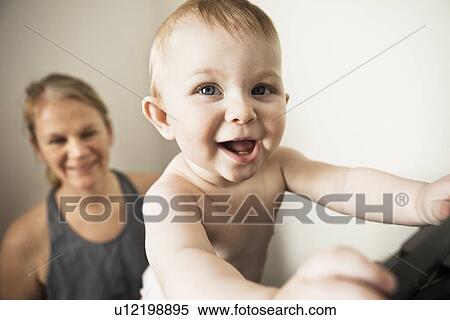 Mother with climbing baby girl View Large Photo Image Stock Photography - Mother with climbing baby girl. Fotosearch